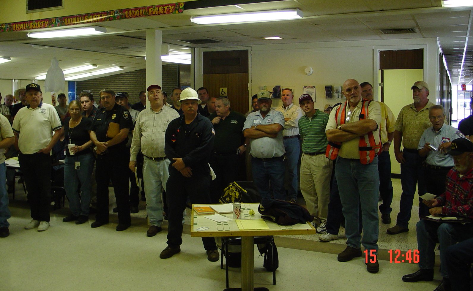 Emergency personnel meet in a building to discuss the best course of action.